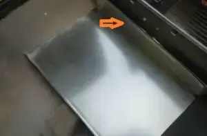 Place the bent plate on the side of the firebox.