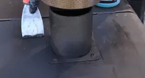 Scraping grease.