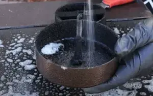 Spray degreaser on the chimney lid.