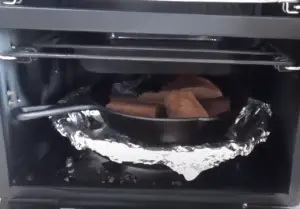 Cast-iron skillet pan inside the smoker.